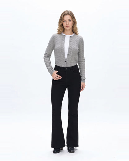 Woman wearing high rise flare denim black jeans with gray sweater and fitted white tee shirt and black boots.