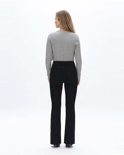 Back view of a woman wearing high rise flare denim black jeans with gray sweater.