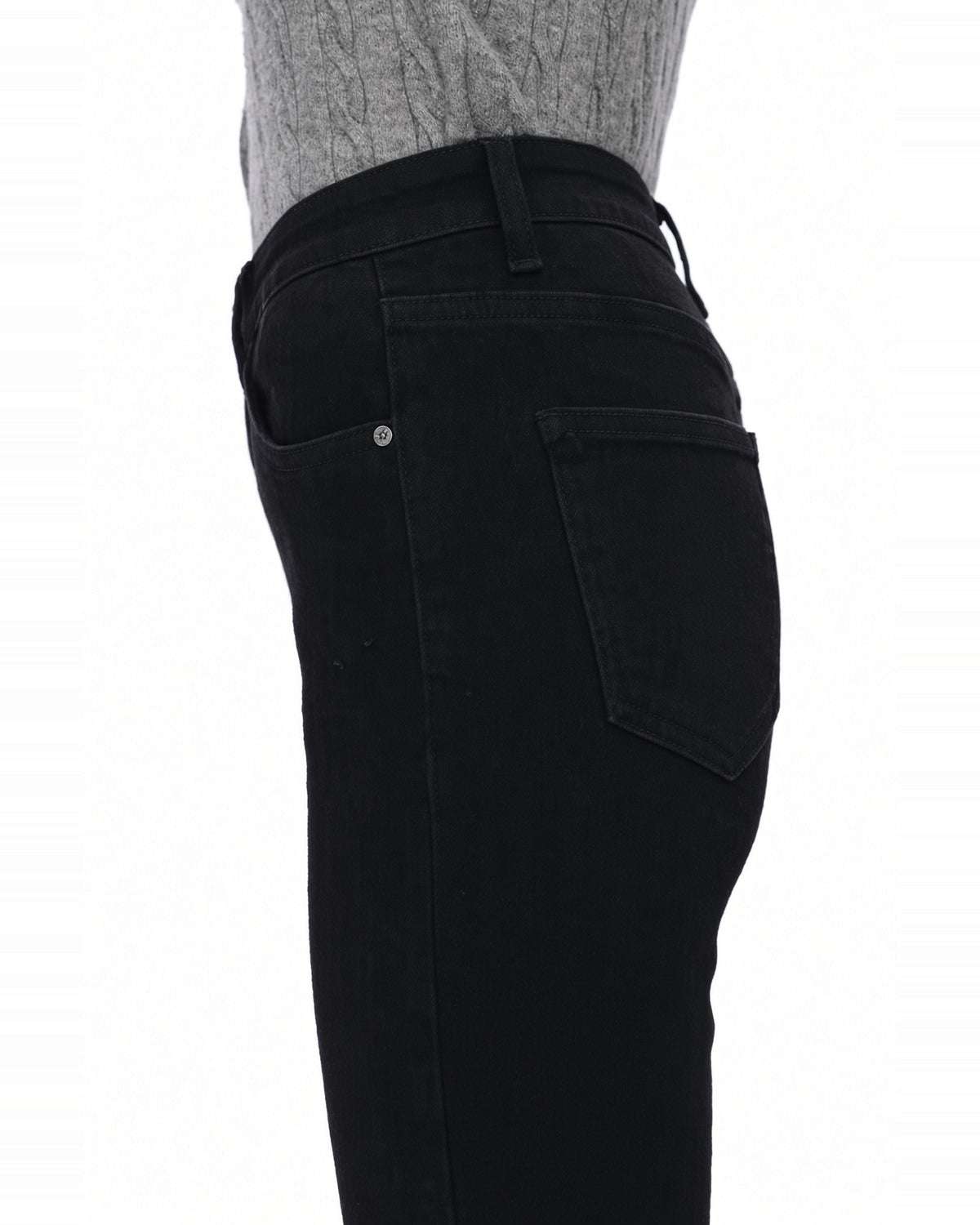 Close up  of the waist and thigh area of the the high rise black flare jeans.