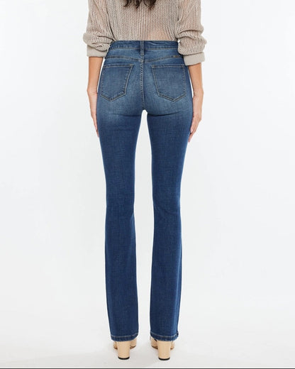 Woman wearing Kan Can High Rise Skinny Bootcut Jeans in medium wash denim.