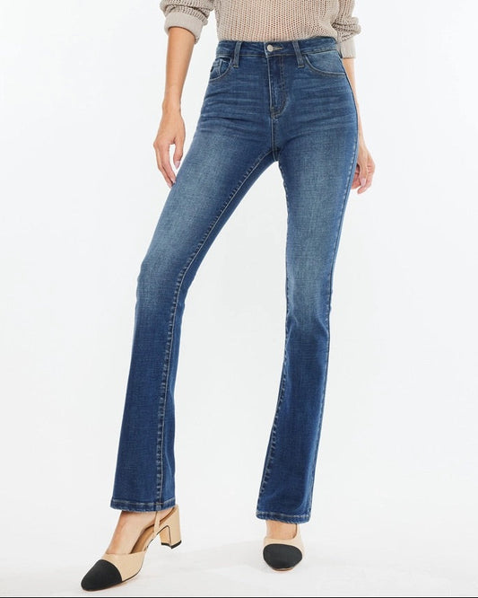 Woman wearing Kan Can High Rise Skinny Bootcut Jeans in medium wash denim.