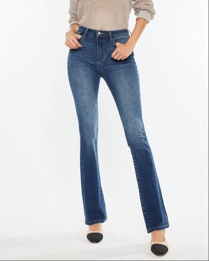 Woman wearing Kan Can High Rise Skinny Bootcut Jeans in medium wash denim.