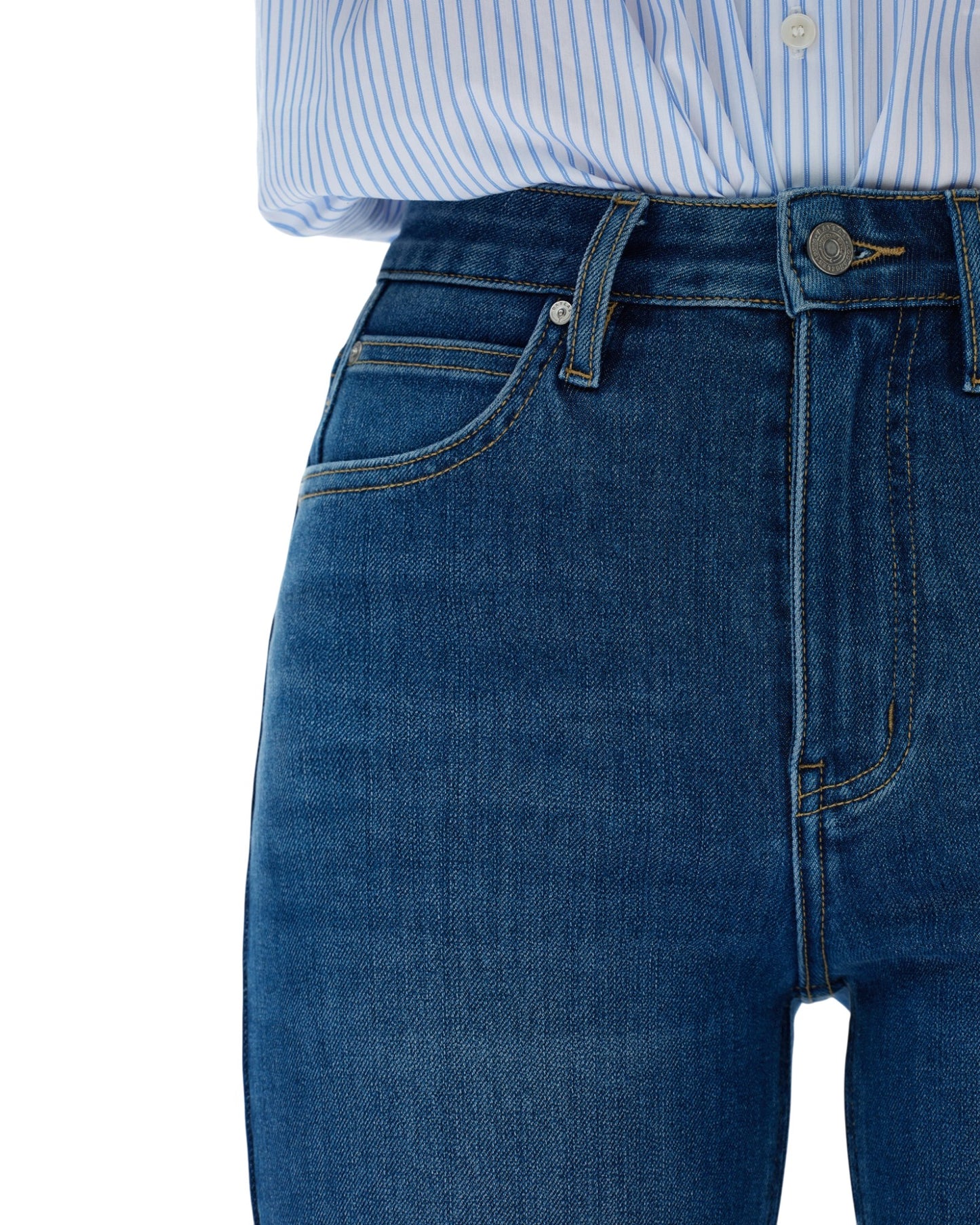 Close-up of blue jeans with a white background.