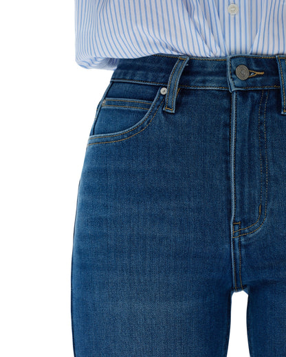 Close-up of blue jeans with a white background.