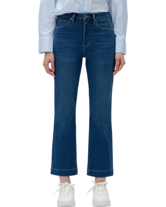 Person wearing blue jeans and a striped shirt on a white background.