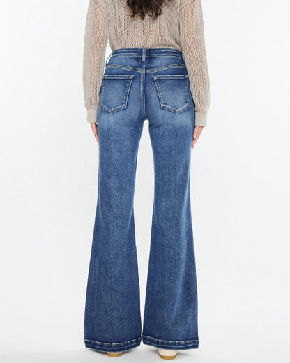 Woman wearing Kan Can High Rise Wide Leg Flare Jeans in medium wash denim.