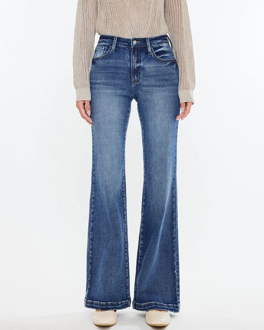 Woman wearing Kan Can High Rise Wide Leg Flare Jeans in medium wash denim.