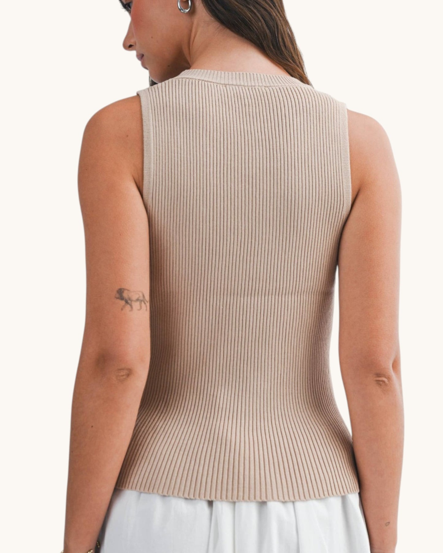 Back view of a woman wearing an Oat round neck ribbed sleeveless top.