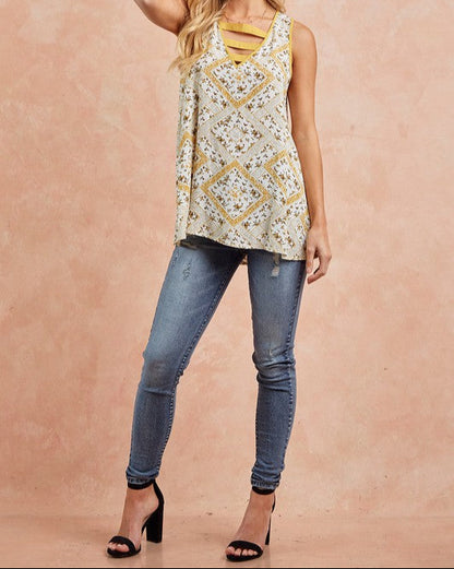 Floral print sleeveless tank top with strappy V-neckline in honey gold and cream.