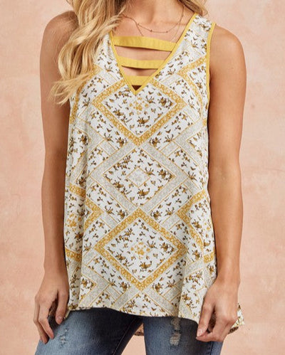 Floral print sleeveless tank top with strappy V-neckline in honey gold and cream.