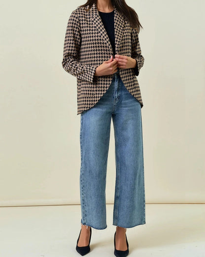 Woman wearing a Houndstooth Shawl Blazer Black and Mocha with open front and modern collar.