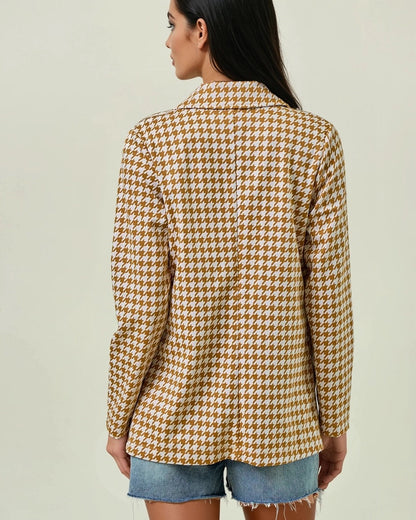 Woman wearing the Houndstooth Shawl Blazer in Ivory and Marigold with open front and modern collar.