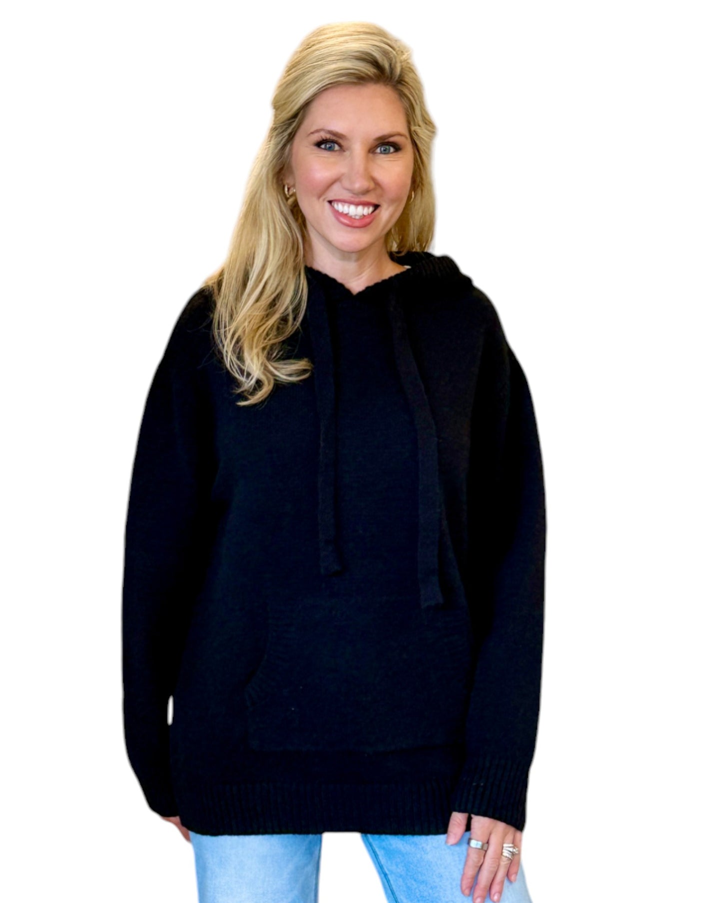 Woman wearing a soft, black oversized hoodie sweater.