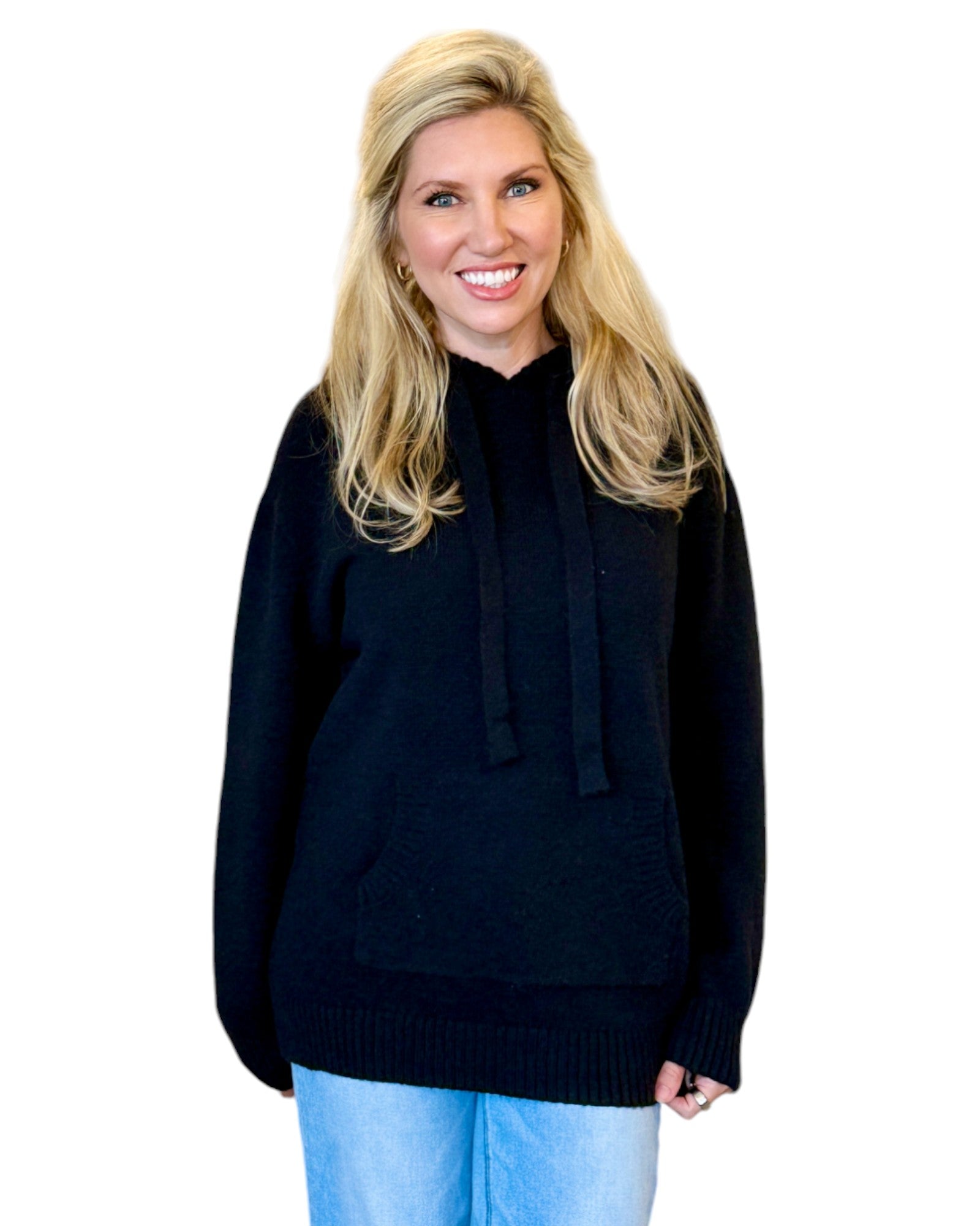Woman wearing a soft, black oversized hoodie sweater.