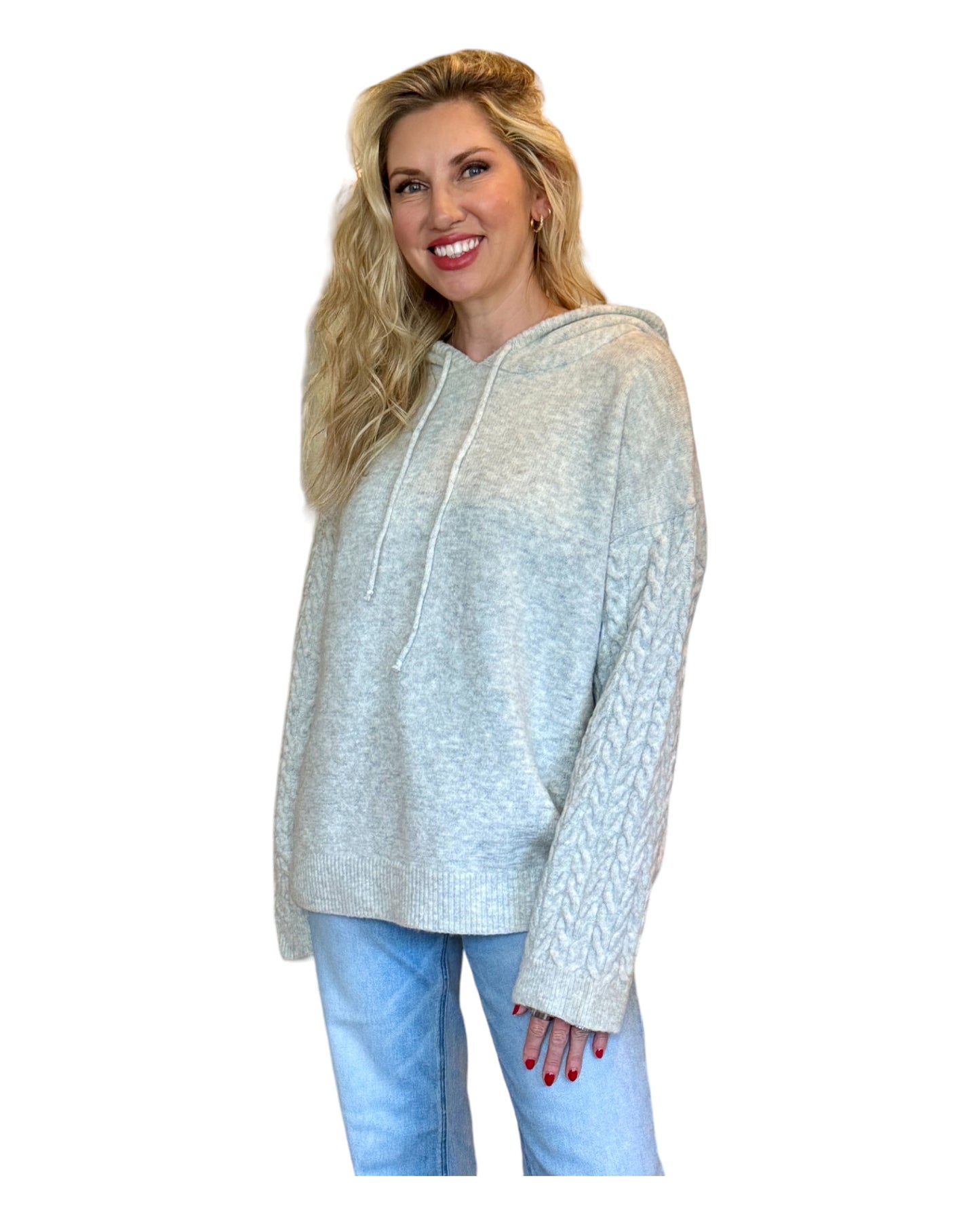 Model wearing an Antique Rose Women's Hoodie featuring wide cable-knit braided sleeves, a cozy marled sweater knit bodice, and an oversized fit.