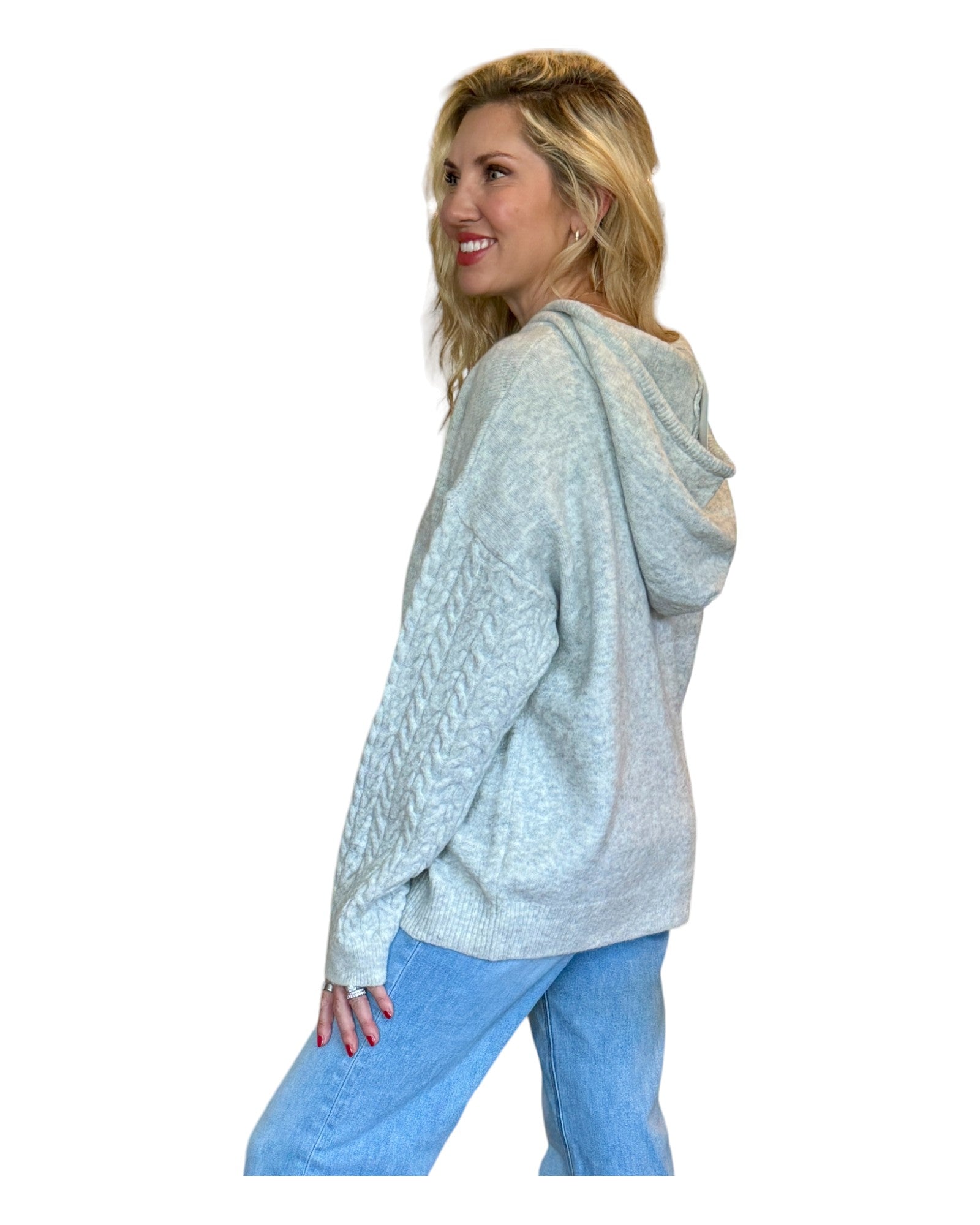 Model wearing an Antique Rose Women's Hoodie featuring wide cable-knit braided sleeves, a cozy marled sweater knit bodice, and an oversized fit.