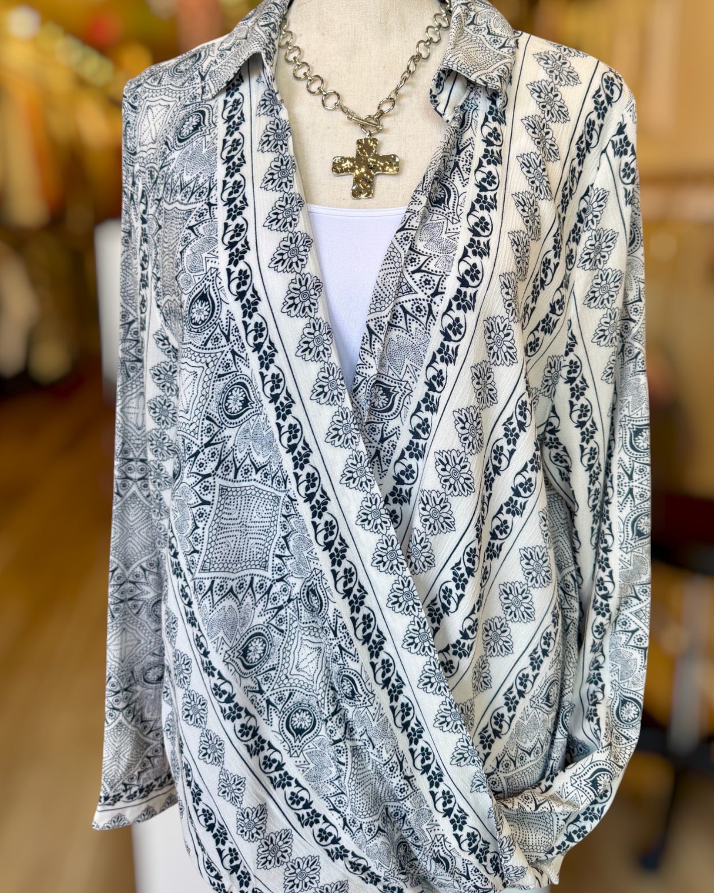 Patterned shirt on a mannequin with a blurred background.