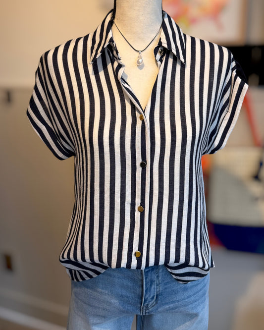 Navy and white striped shirt on a mannequin with a blurred background