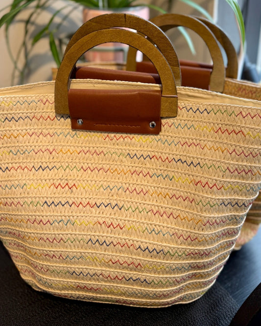 Woven straw bag with wooden handles.