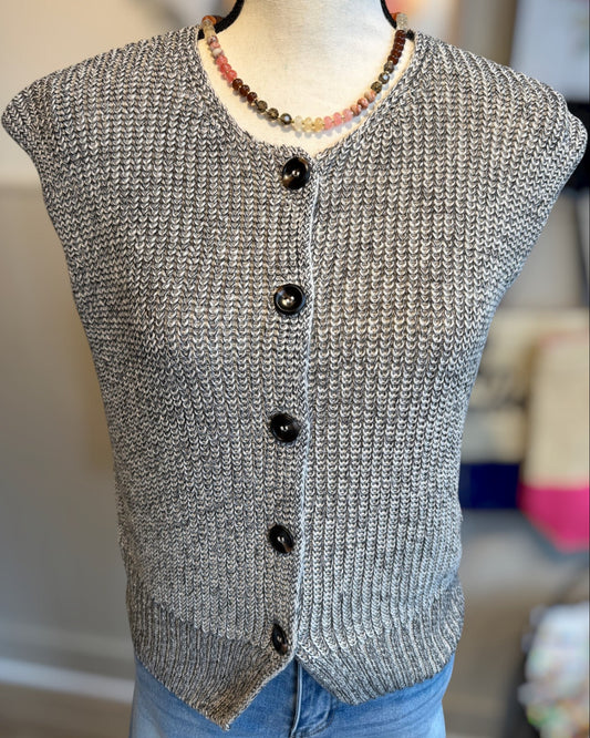 Gray knitted sleeveless vest with buttons on a mannequin against a neutral background.