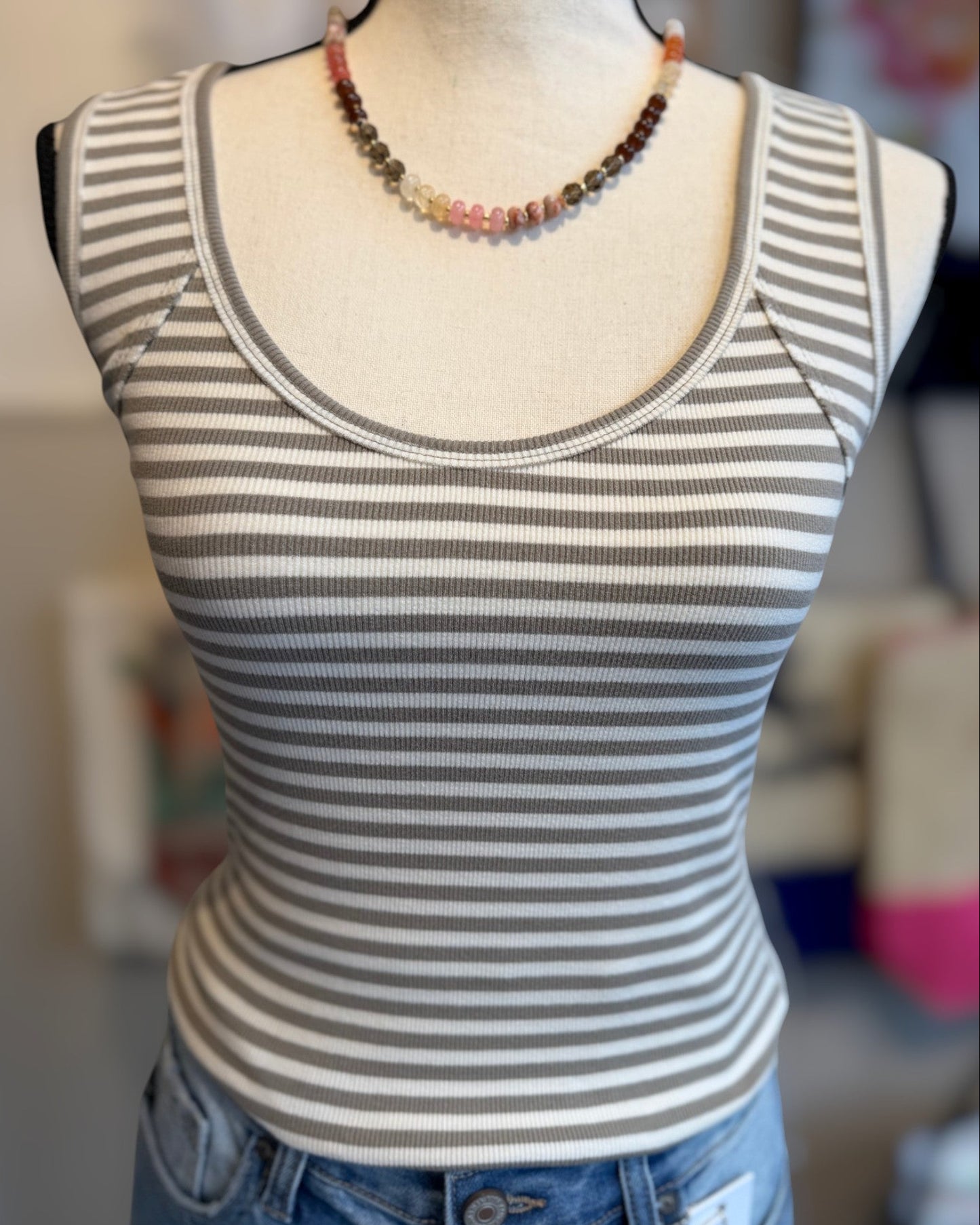 Striped tank top on a mannequin with a blurred background
