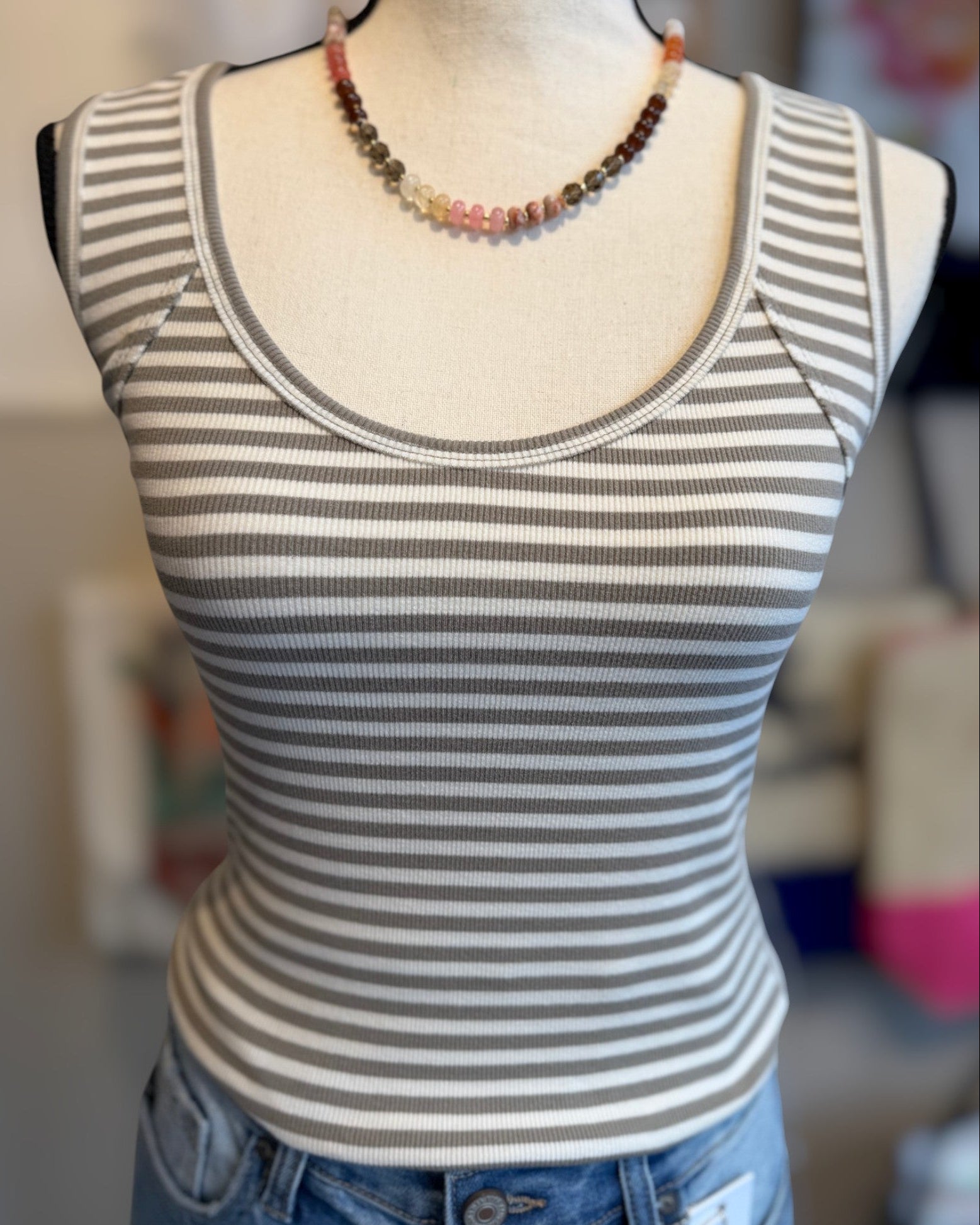 Striped tank top on a mannequin with a blurred background
