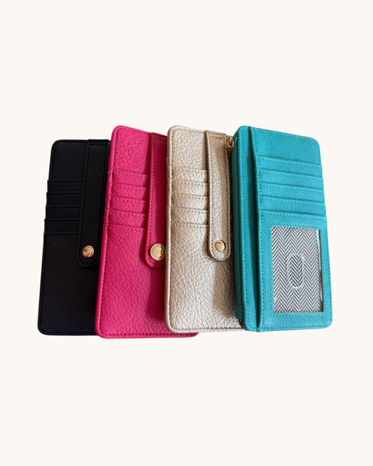 Four colorful wallets (black, pink, beige, blue) arranged in a row on a white background.
