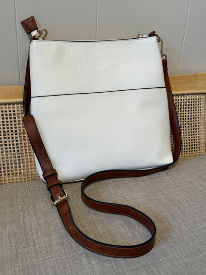 A white leather shoulder bag with a brown leather strap and trim, displayed on a textured beige surface against a neutral background.