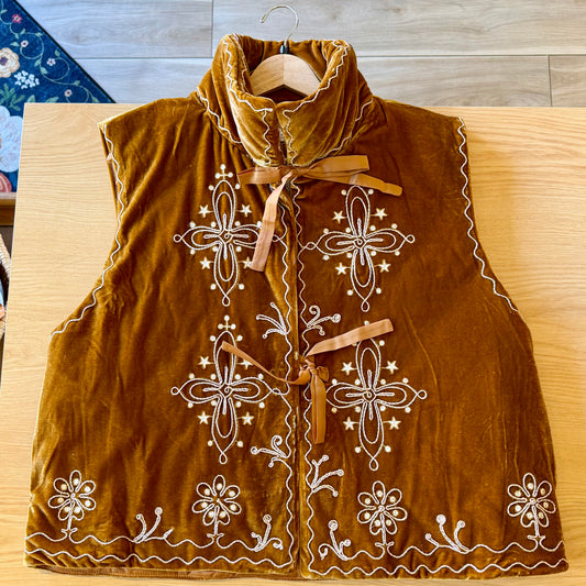 Velvety caramel coppery brown vest with ivory and gold threaded embroidered floral accents with tall collar and ribbon ties. 