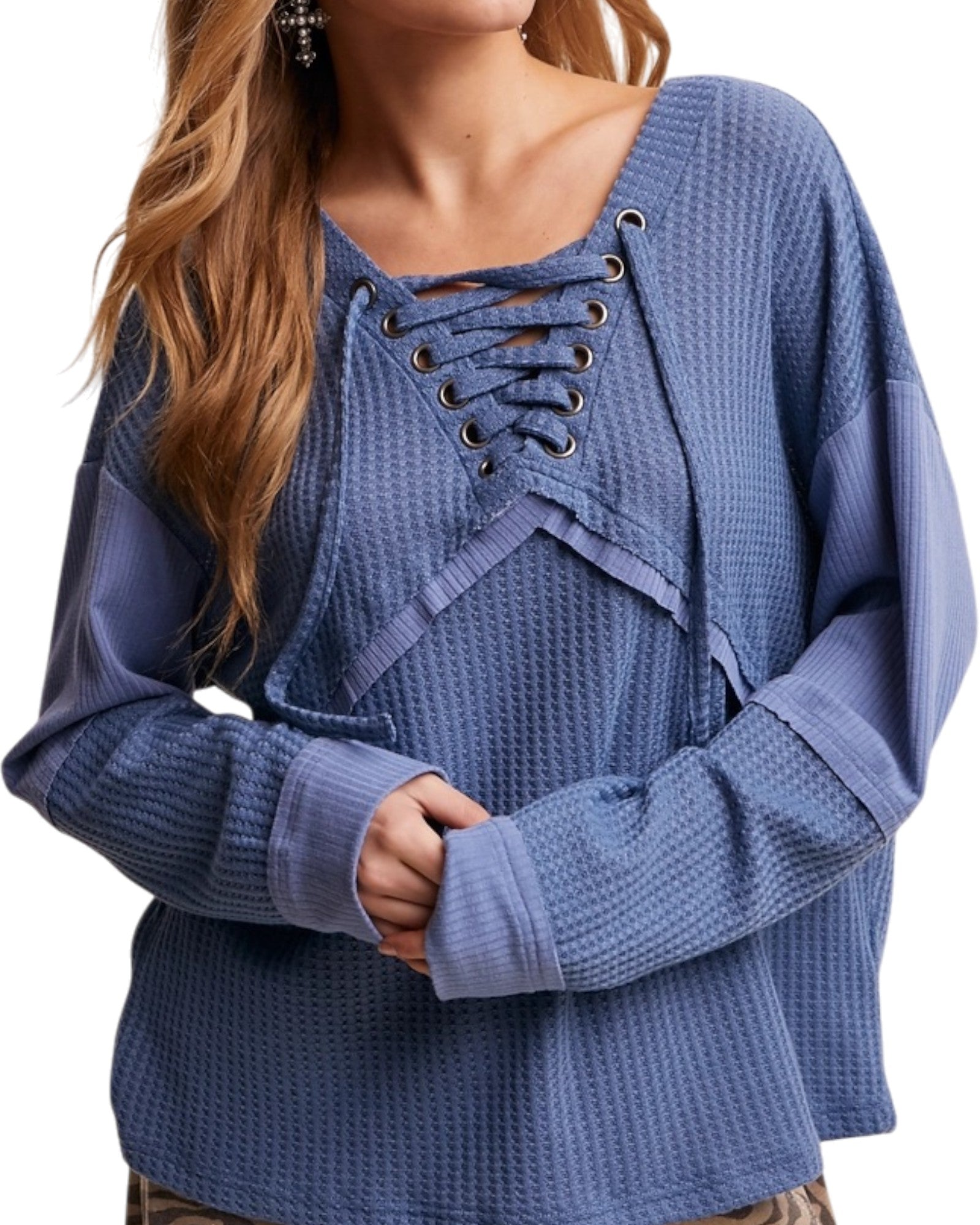 Blue textured casual top with lace-up front worn by a person, on a white background.