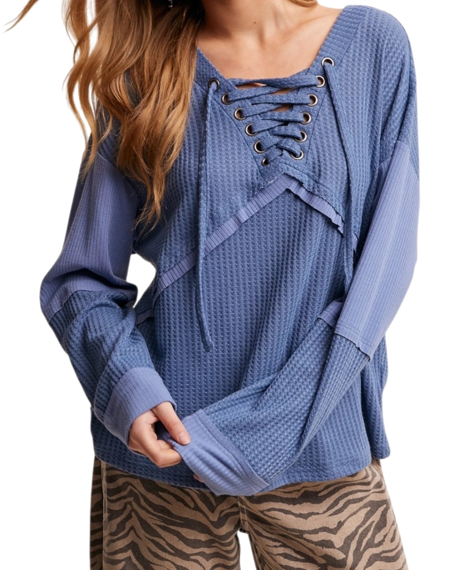 Blue textured casual top with lace-up front worn by a person, on a white background.
