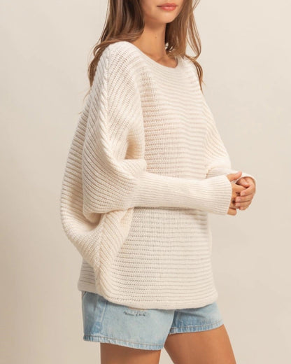  Ivory oversized dolman sweater with wide-knit texture and relaxed fit.