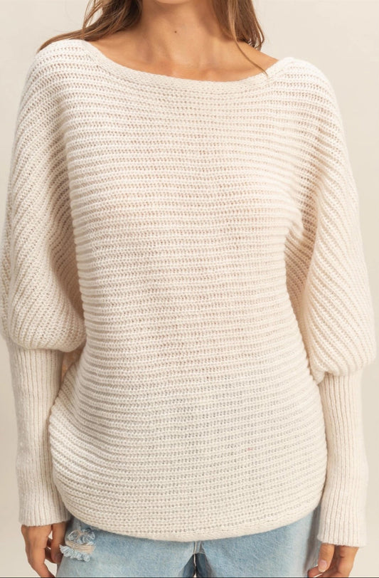  Ivory oversized dolman sweater with wide-knit texture and relaxed fit.