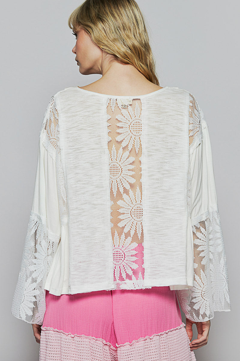 White V-neck relaxed-fit boho top with flare sleeves and floral lace detailing.