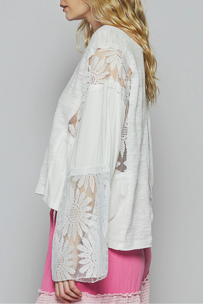 White V-neck relaxed-fit boho top with flare sleeves and floral lace detailing.