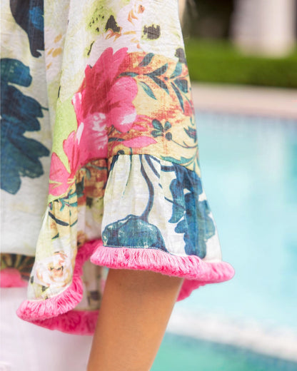 Close up of a colorful floral sleeve with pink fringe trim.