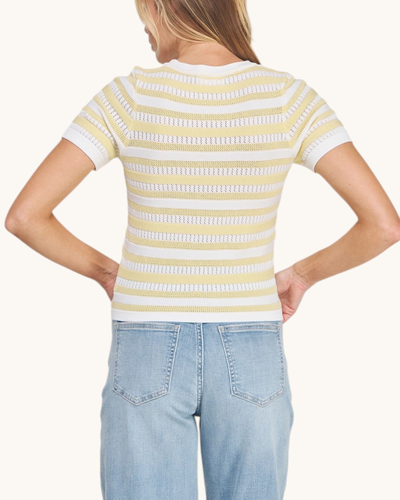 Back view of a Limoncello Fine Gauge Knit Top in a sunny yellow and white.