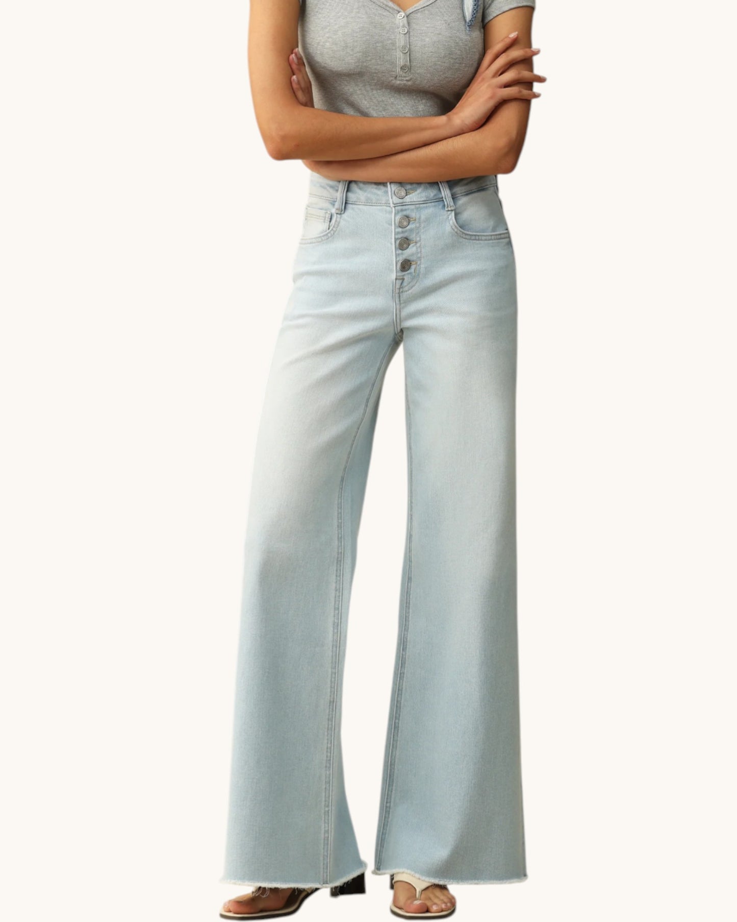 Light blue jeans worn by a person on a white background