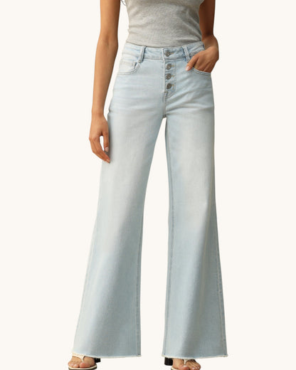 Light blue jeans worn by a person on a white background.