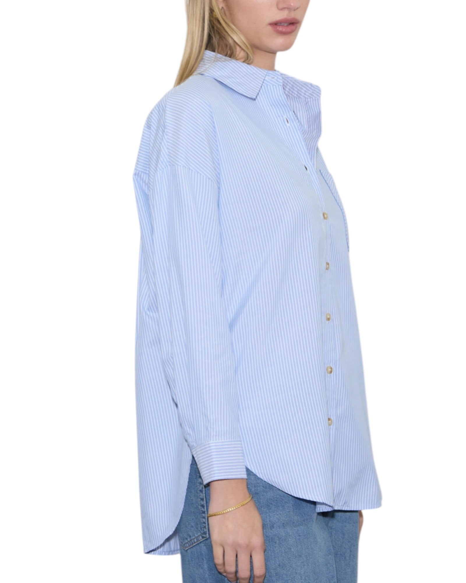 Woman wearing a light blue striped shirt on a white background.