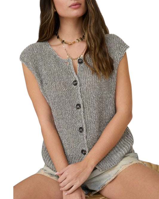 Woman wearing a gray sleeveless knitted vest on a white background.