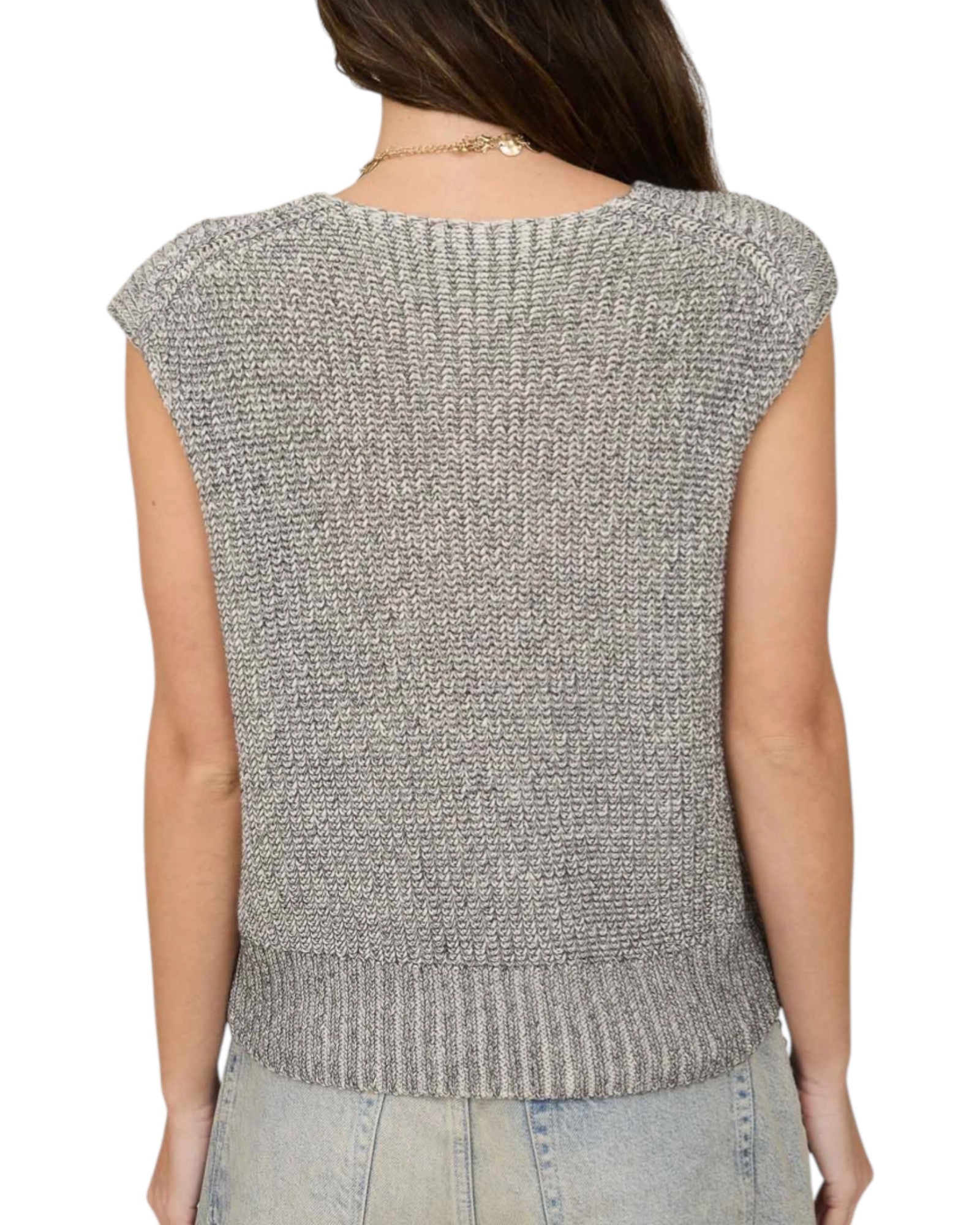 Back view of a person wearing a sleeveless knitted vest on a white background.