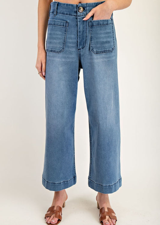 Medium wash wide-leg denim pants with front patch pockets and contrast seaming.
