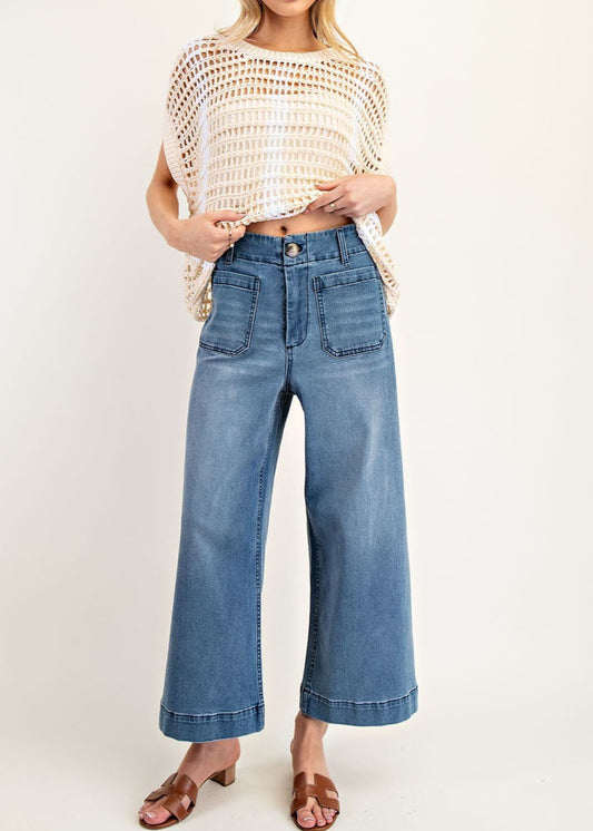 Medium wash wide-leg denim pants with front patch pockets and contrast seaming.