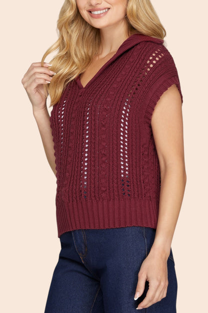 Woman wearing a Mulberry colored short sleeve open knit sweater with v-neckline and flap collar. 