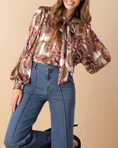 Multi-color paisley tie neck blouse with smocked cuffs.