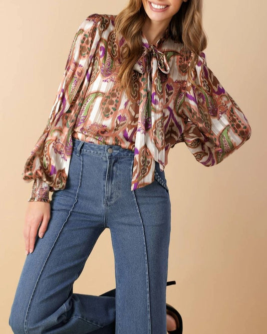 Multi-color paisley tie neck blouse with smocked cuffs.