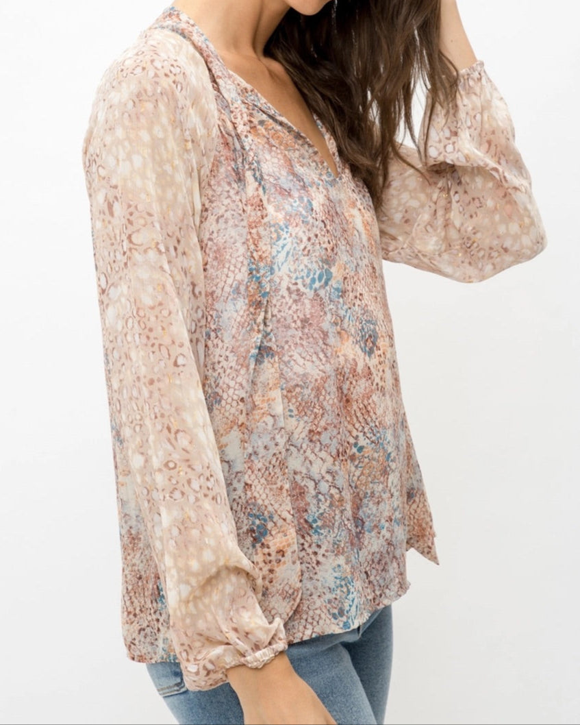 Mixed animal print patterned semi-sheer long sleeve blouse with a V-neckline and tie front. 