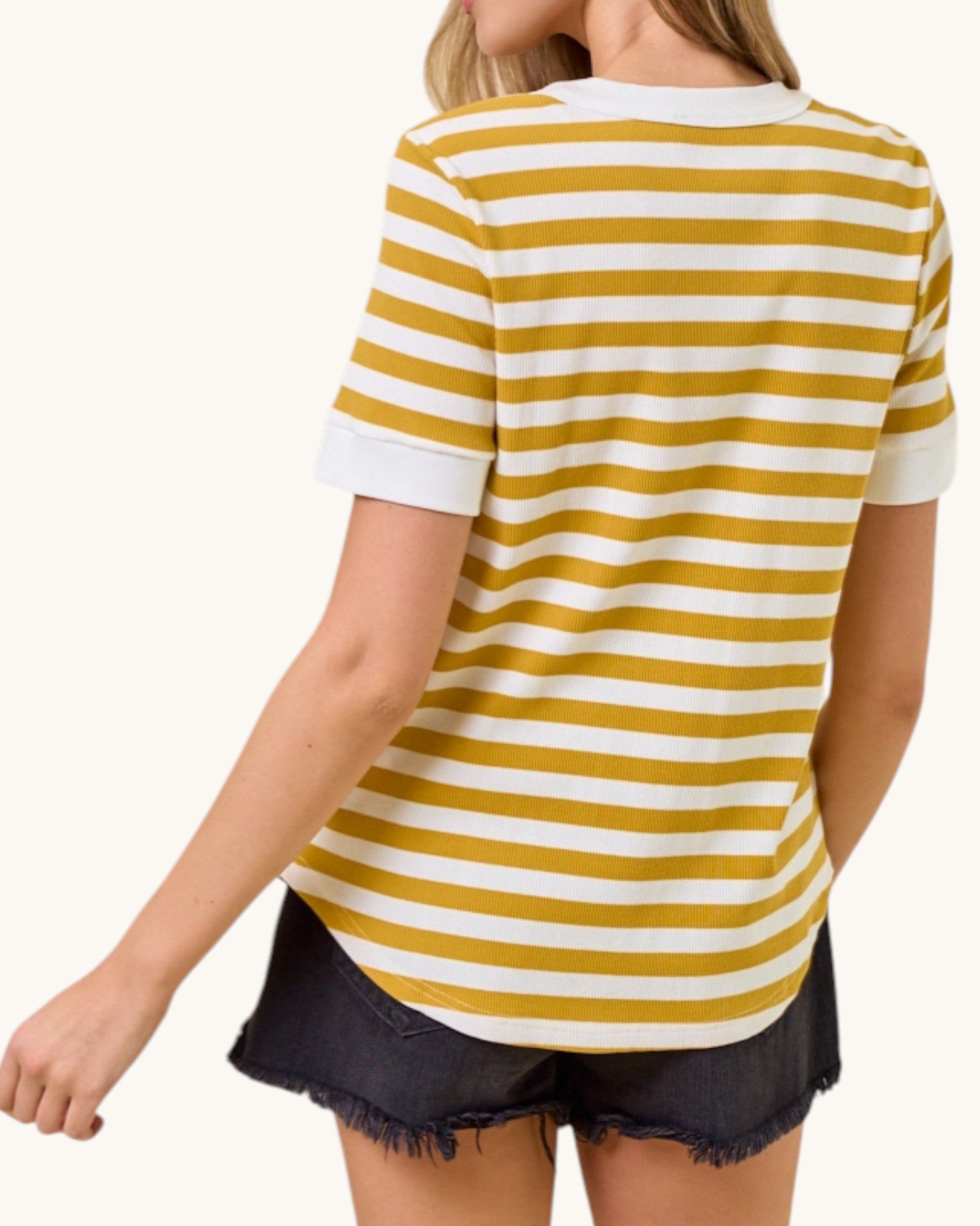 Person wearing a yellow and white striped shirt on a white background.