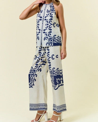Navy and ivory halter-style sleeveless top with bold ornamental print.